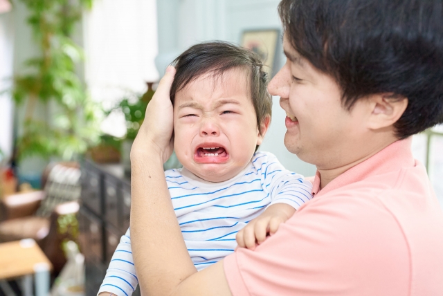 パパに抱っこされて大泣きの子供